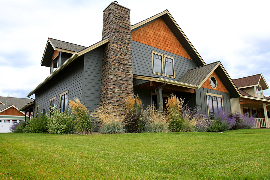 Mature tree and shrub installation along a property line