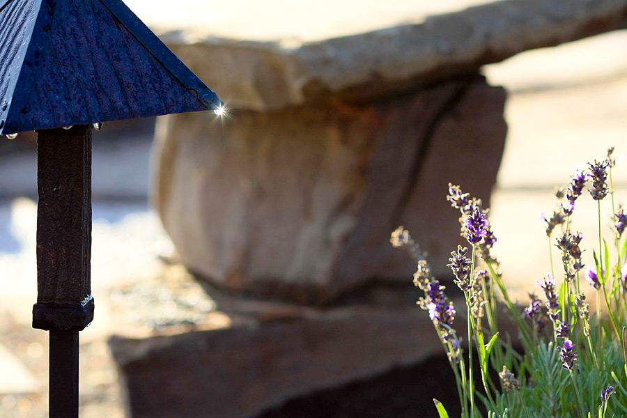 Outdoor living space with flagstone walkway and lighting